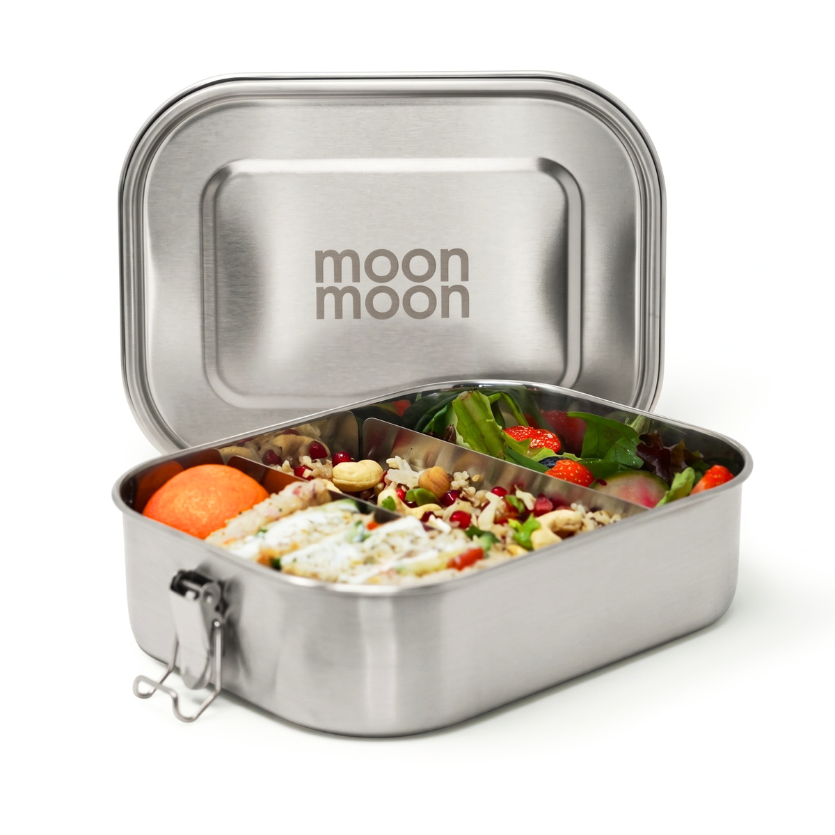 A large stainless steel lunch box with its lid propped open, showing a divided tray filled with a colorful salad, crackers, and fruit. The inside of the lid is brushed silver with moonmoon printed on the lid.