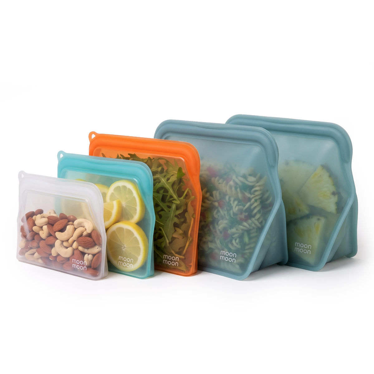 Five moonmoon reusable silicone food storage bags in translucent aqua, orange, and gray-blue sizes, shown filled with nuts, lemon slices, greens, and pasta on a clean white background. 